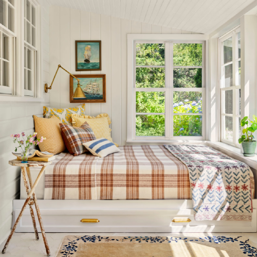 Sleeping porch with daybed in a beach cottage by Wildflower Home (Marynn) featured in Country Living.