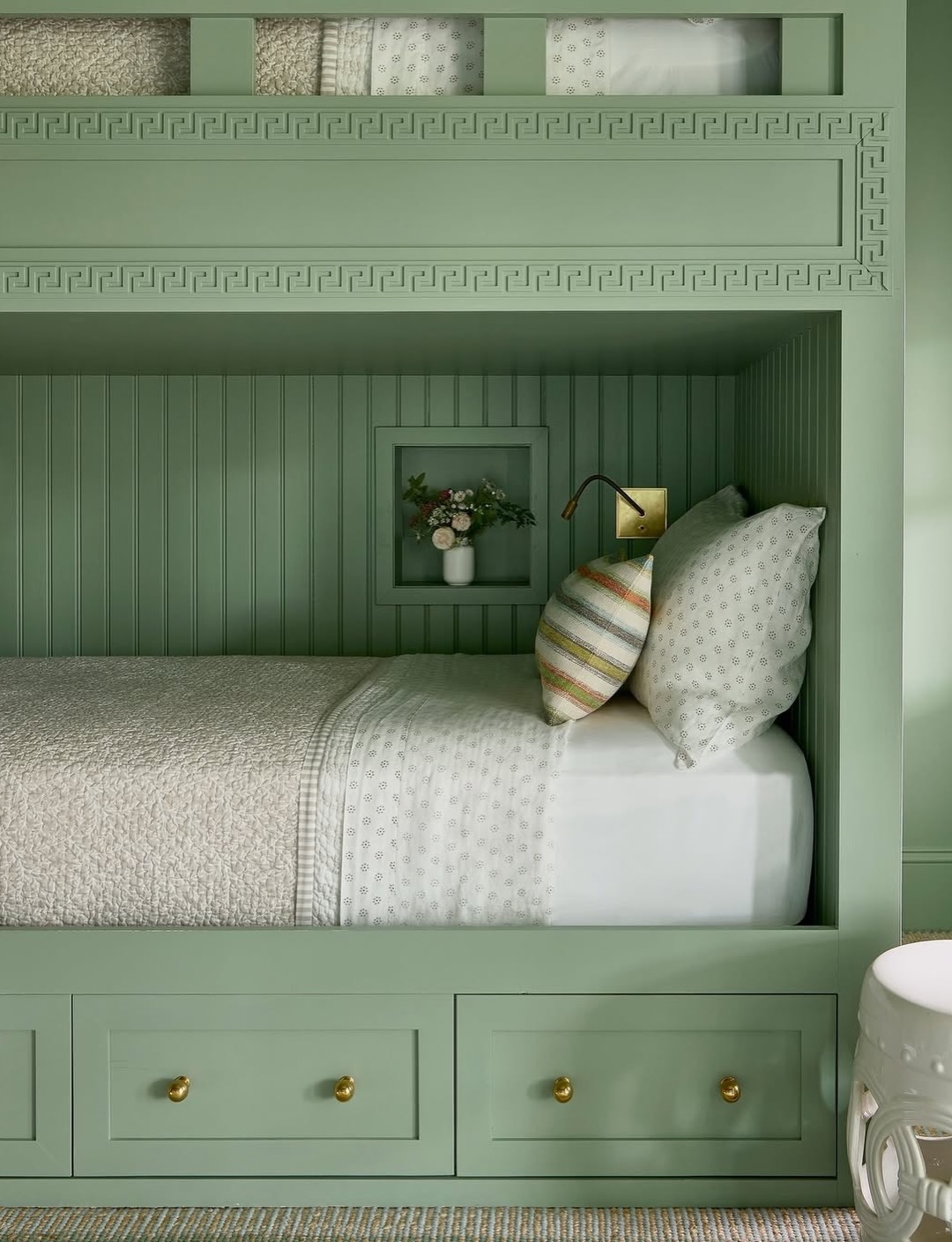 Green painted built-in bunks in a space by @kendallrabuninteriors.