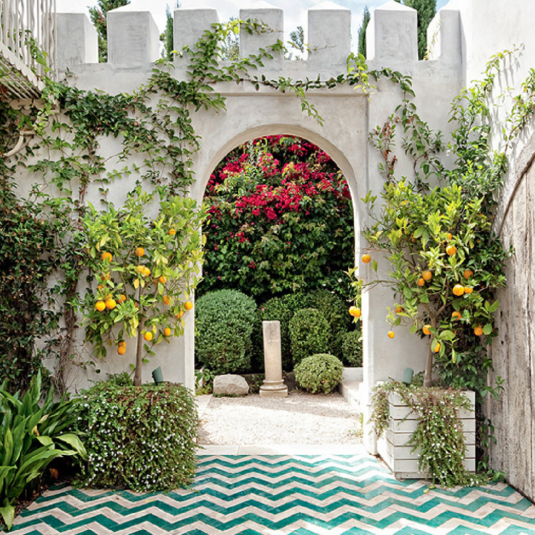 Chevron pavers, castle architecture, lush garden and citrus in courtyard of Richard Shapiro's masterful Old World seaside home in Malibu in AD's April 2011 issue.