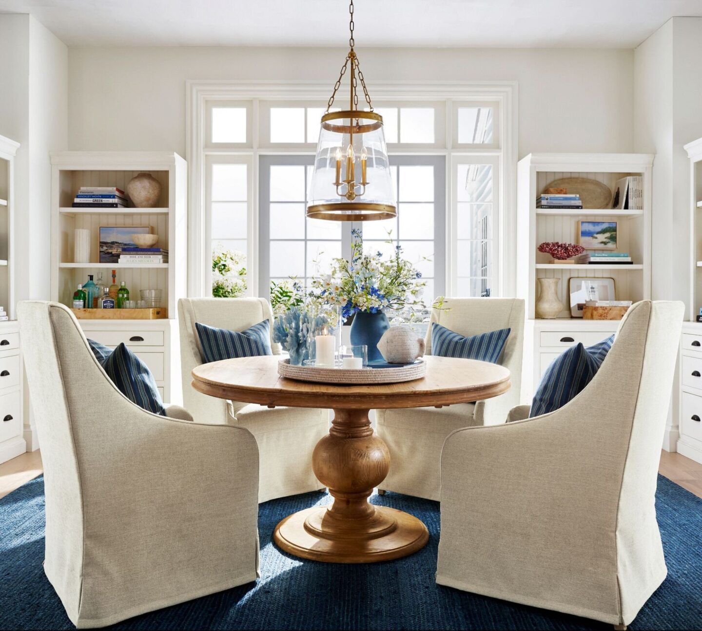 Heritage farmhouse pedestal dining table with slope armed chairs from Pottery Barn. #coastaldiningroom #classiccoastal