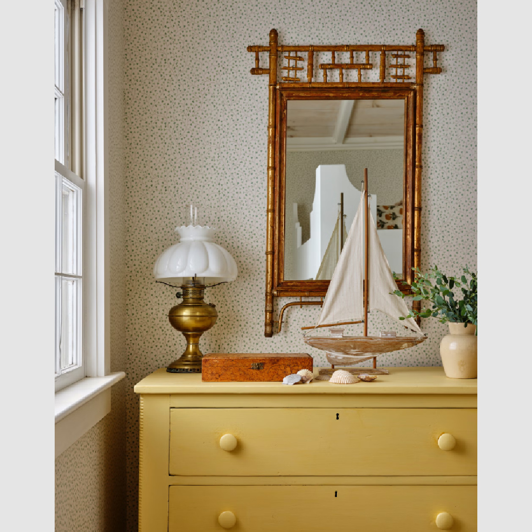 Beautiful yellow vintage dresser in a coastal cottage bedroom with romantic, nostalgic modern country charm - design by Wildflower Home Interiors in COUNTRY LIVING magazine.