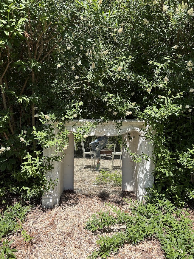 An antique French fireplace surround in my French country courtyard at the Georgian - Hello Lovely Studio.