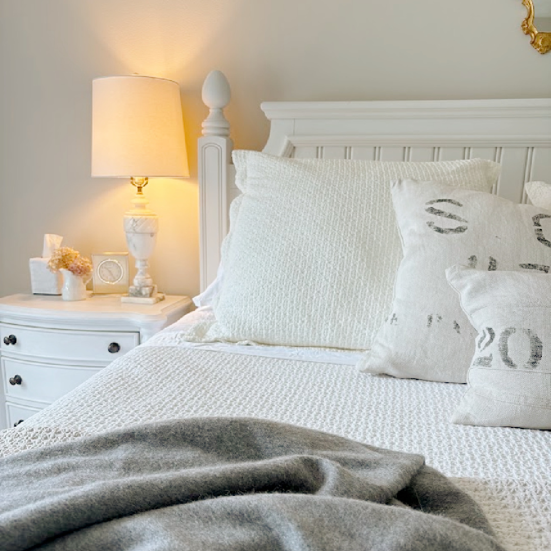 Hello Lovely's bedroom with Honeydew sheets and pillows on bed. Wall color is SW Agreeable Gray.