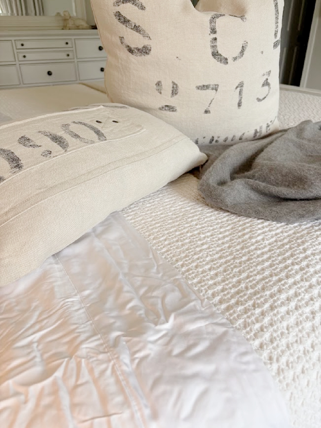 Hello Lovely's bedroom with Honeydew sheets and grainsack pillows on bed.