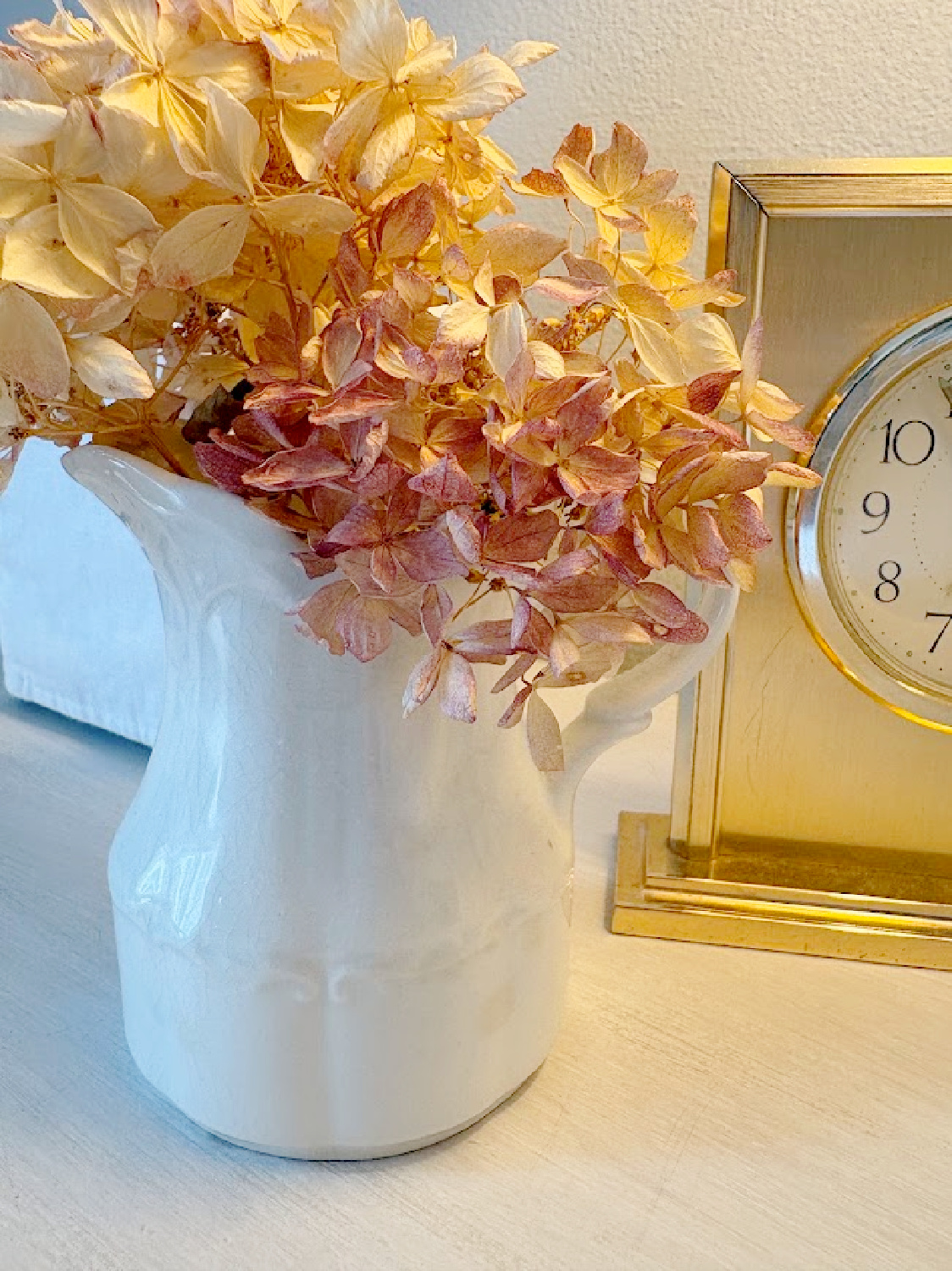 Antique ironstone pitcher with dried hydrangea from the yard on my nightstand at the Georgian.