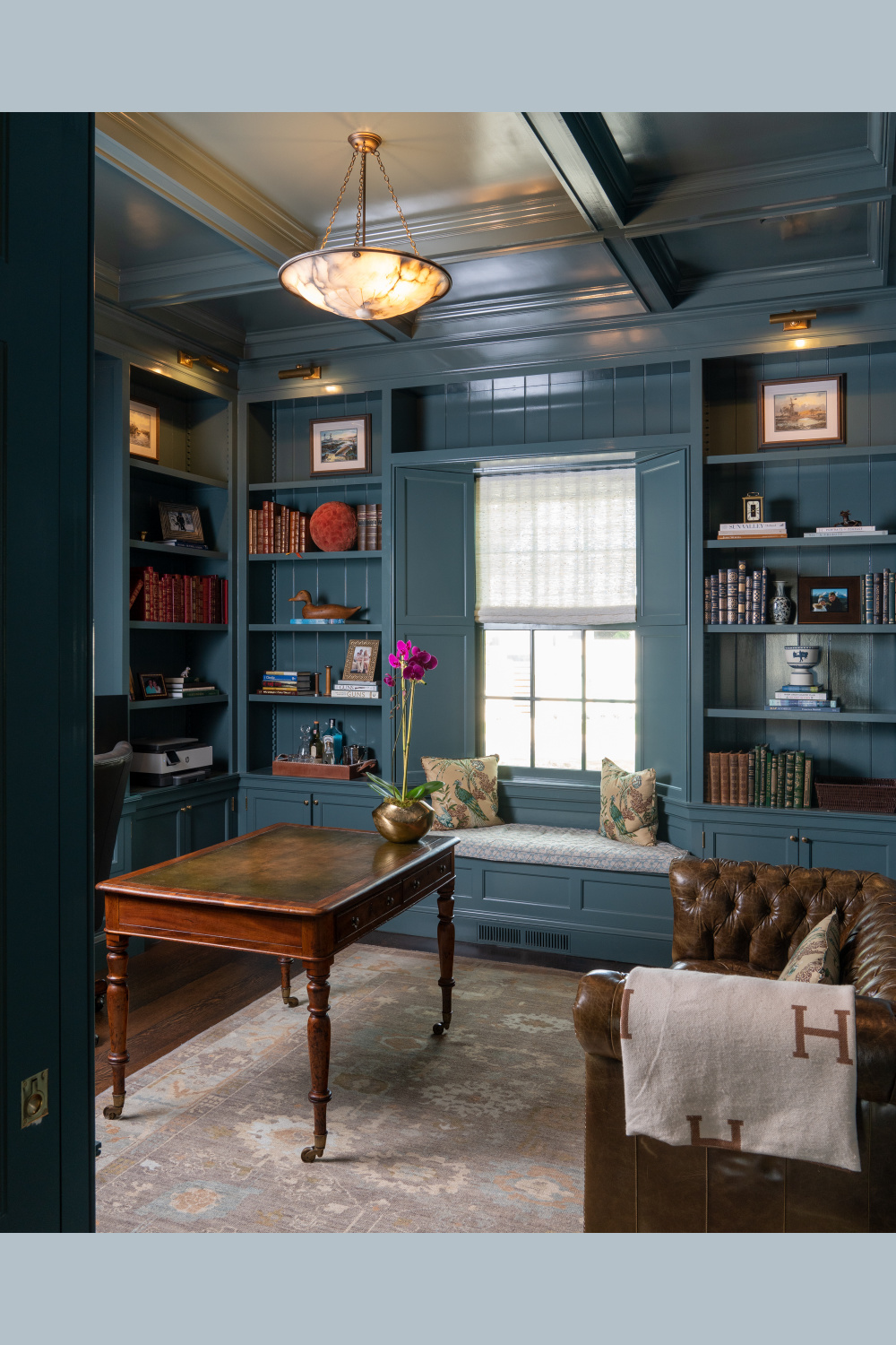Study with moody deep blue gray and lacquered ceiling in a Cathy Kincaid designed historical Charleston home.