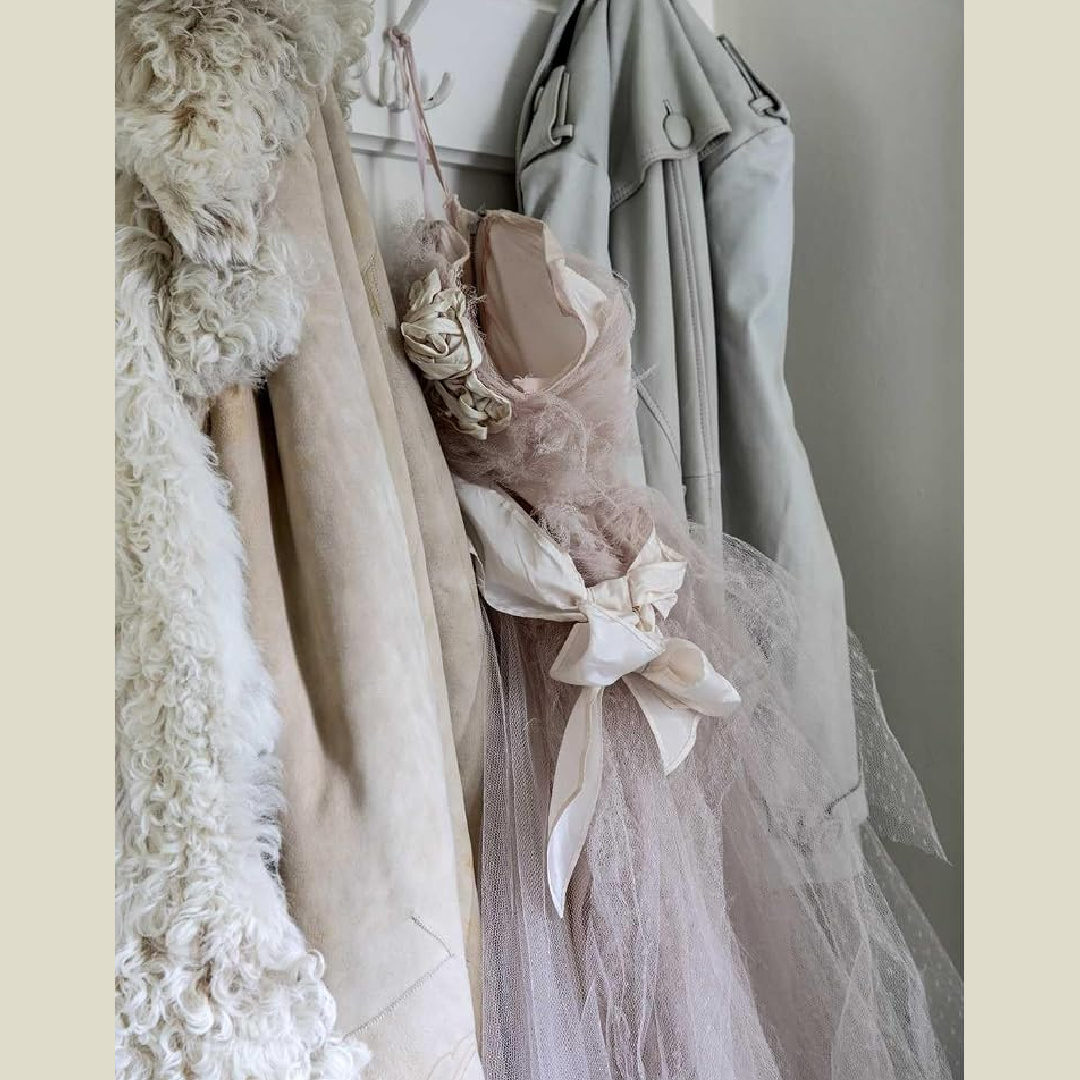 Vintage pale pink prom dress and pastel clothing on hooks in entry of Rachel Ashwell's English countryside home known as Meadow Manor. Photo: Amy Neunsinger.