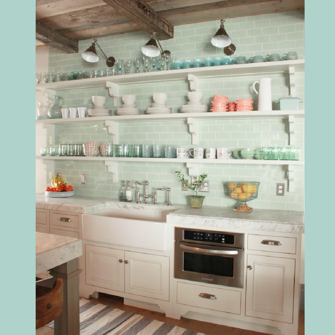 Open shelving with ironstone and jadeite in kitchen with light cool green subway tile. French, Belgian and Gustavian influences in a rustic elegant Utah cottage - Desiree Bastian of Beljar Home.