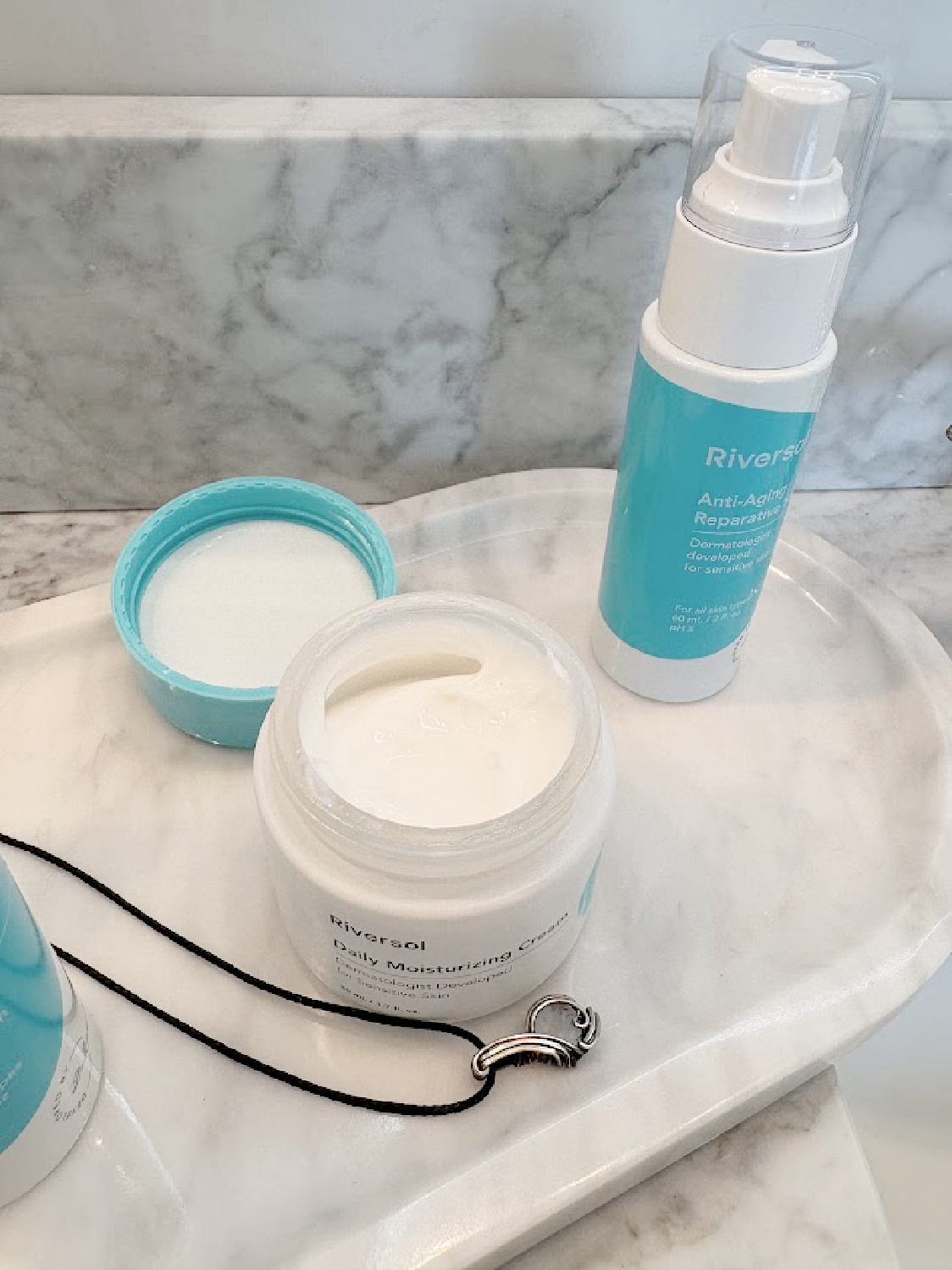 Riversol Skincare products on Hello Lovely's carrera marble vanity top.