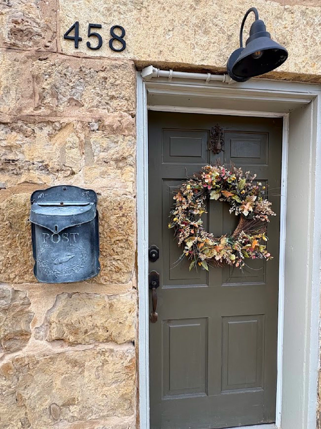 Charming front door with fall wreath and vintage mailbox. Historic Galena, IL limestone house built in 1827 - Daniel Harrison House (458 Dewey Ave) - photo by Hello Lovely Studio.