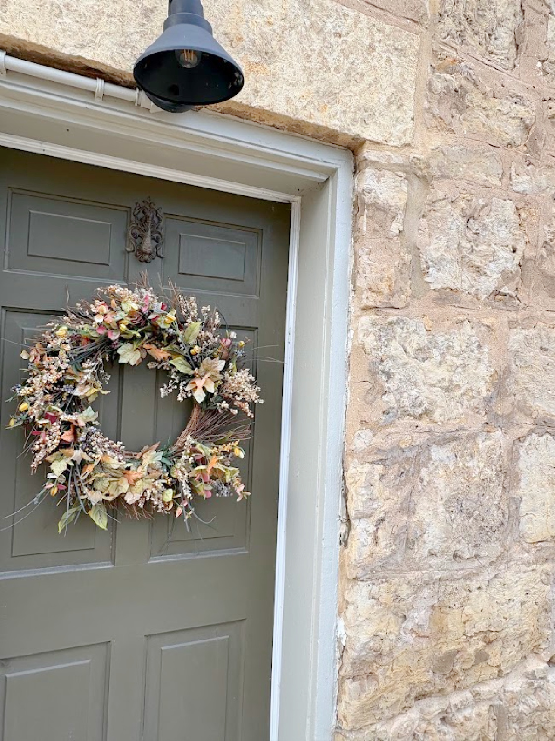Subdued and gentle fall colors on wreath and stone - historic Galena, IL limestone house built in 1827 - Daniel Harrison House (458 Dewey Ave) - photo by Hello Lovely Studio.