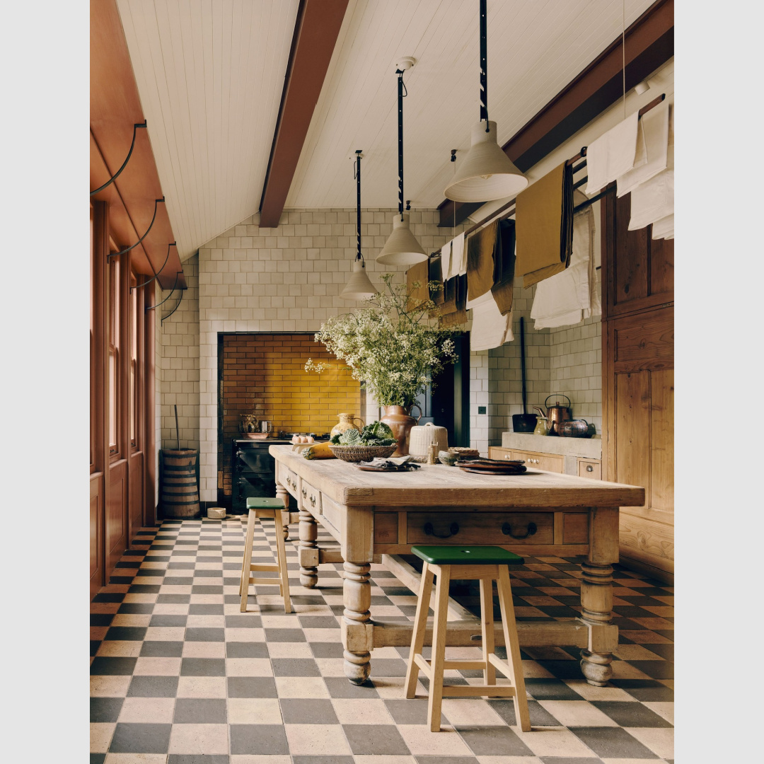 Checkerboard flooring in a cozy country kitchen - House and Garden UK.